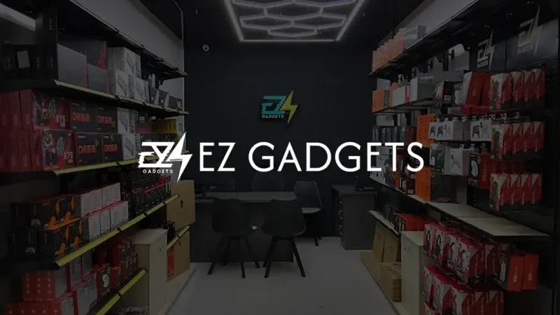 The EZ Gadgets logo over a photo of the shop: walls of boxed keyboards, controllers and accessories.