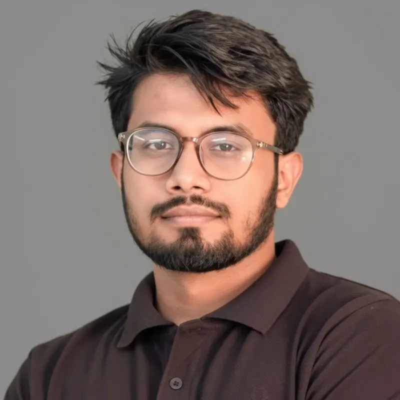 Portrait of Fahim Ahmed, in glasses and a dark shirt.