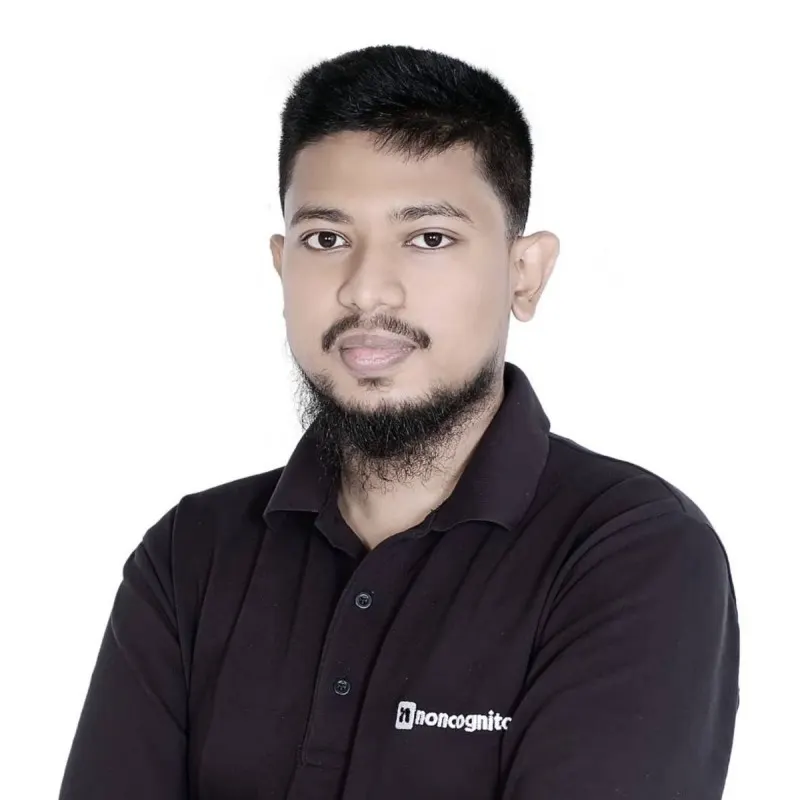 Portrait of Mahir Abdullah, in a black polo shirt against a white background.